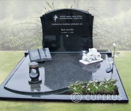 Groot grafmonument met boek, traktor en lantaarn